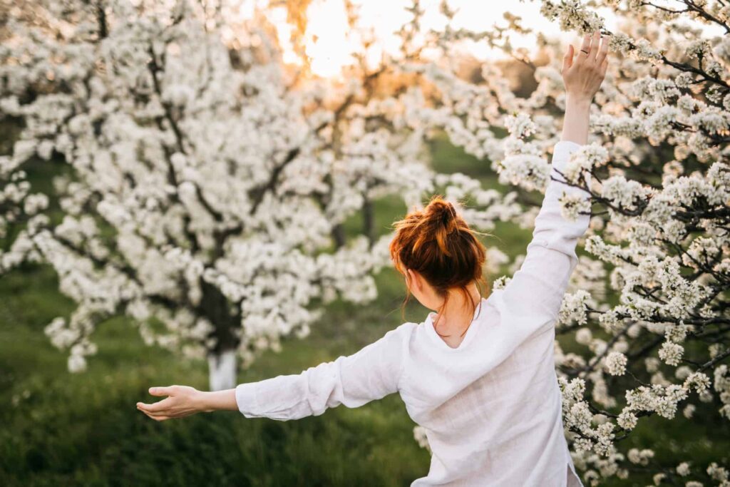 Woman Relaxing in Sunset in Back Yard
