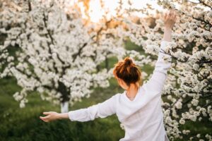 Woman Relaxing in Sunset in Back Yard