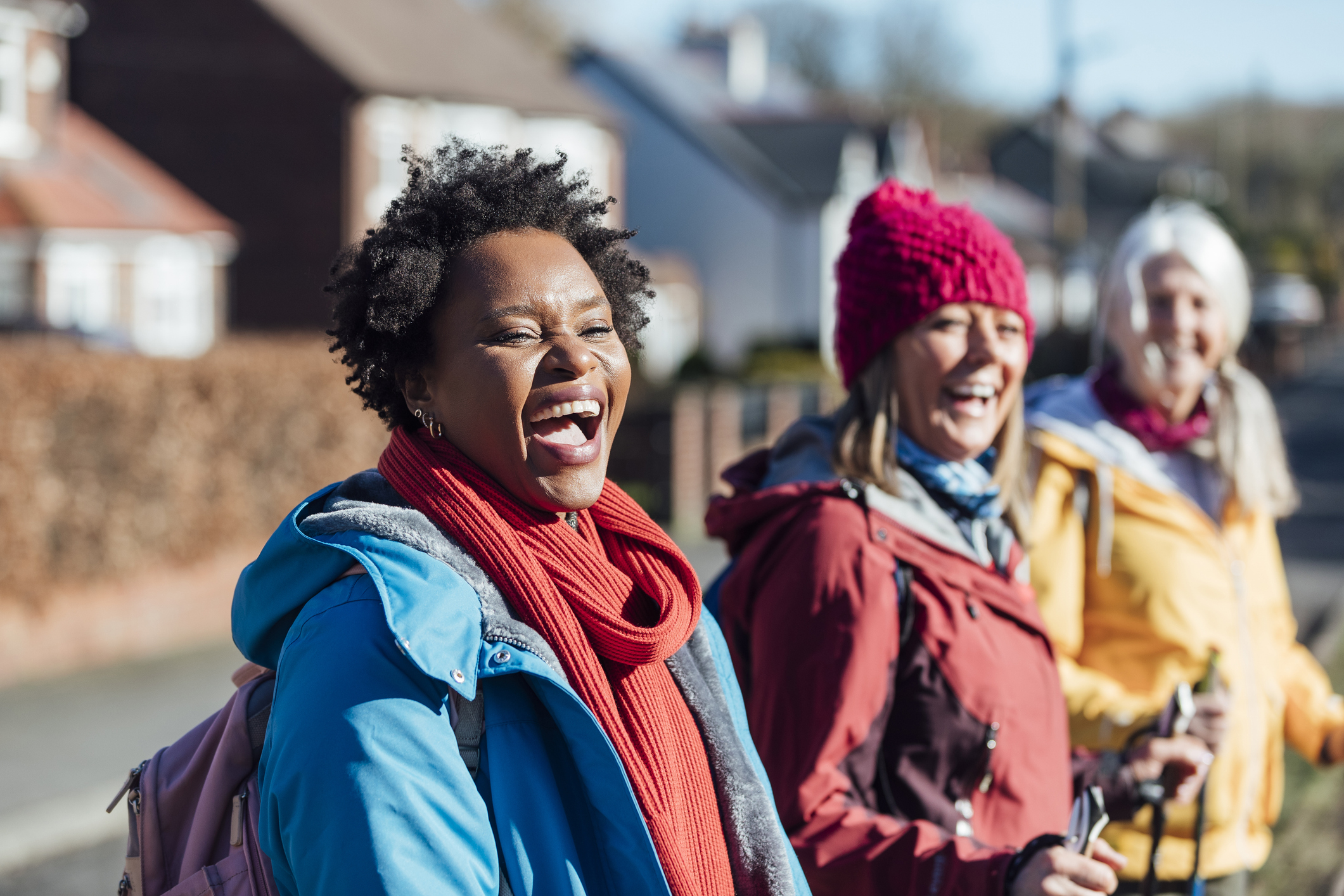 A group of three female friends meeting up in a residential area before spending the day together out Hiking in Seaham in the North East of England