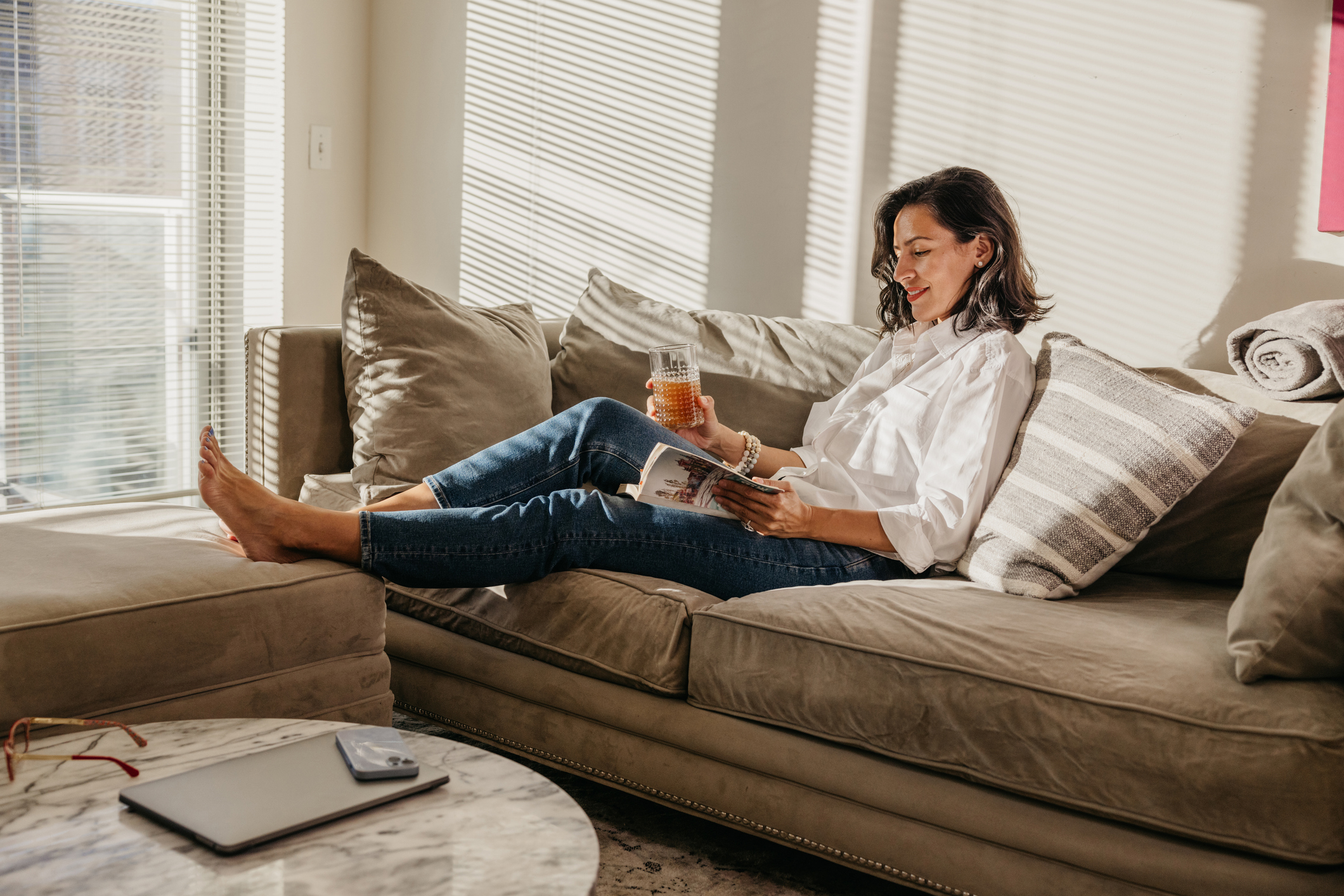 Woman enjoying a day off and reading a book on the couch