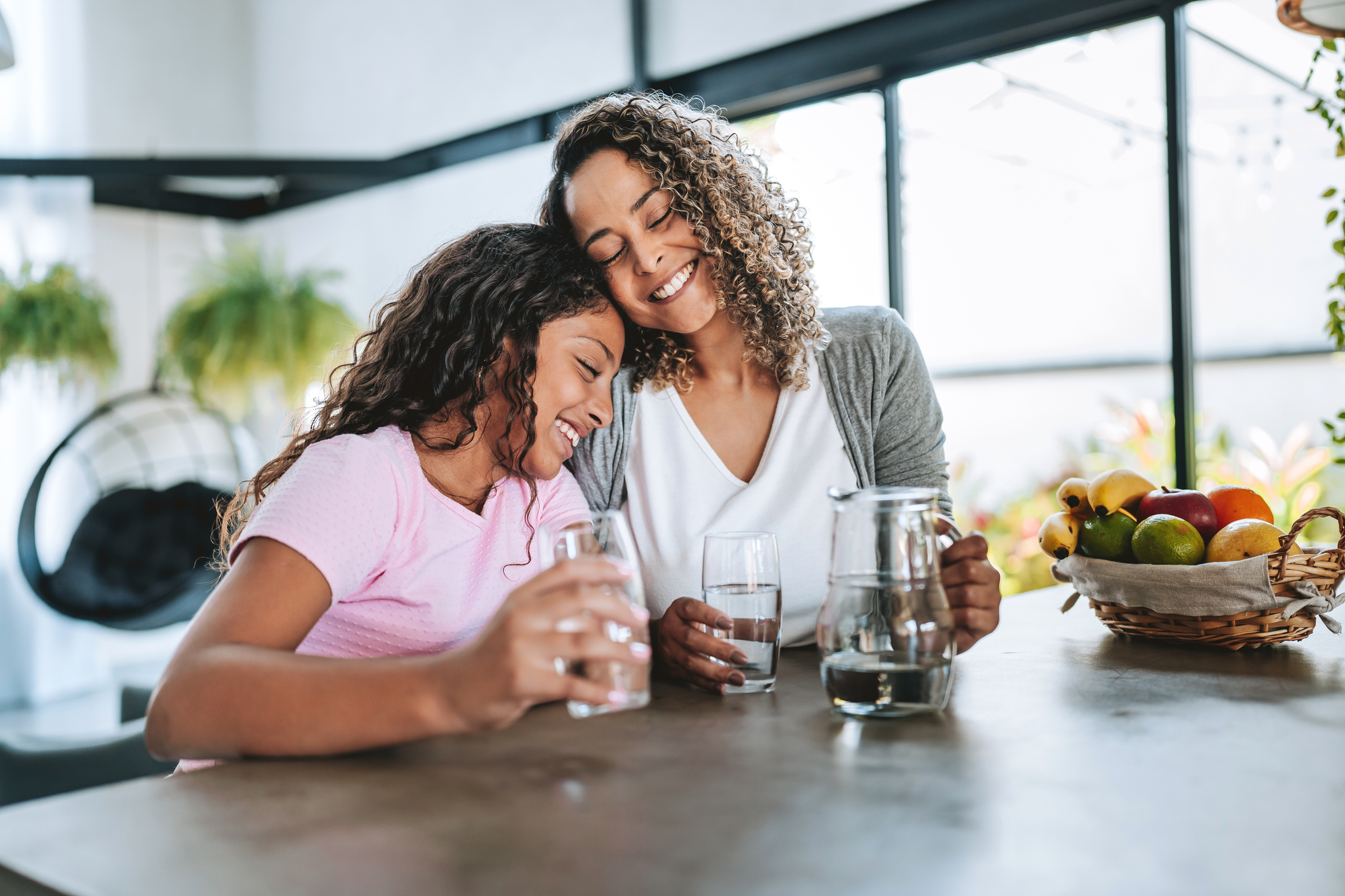 Mother and daughter drinking water together